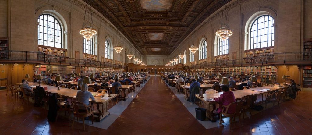 people reading quietly in a public library